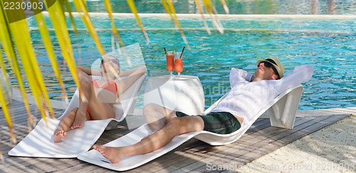 Image of happy young couple have fun on beach