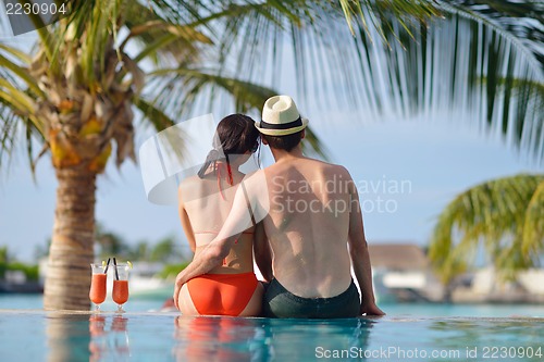 Image of happy young couple have fun on beach