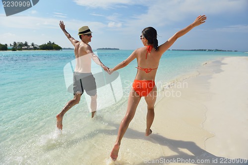 Image of happy young couple have fun on beach