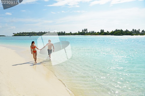 Image of happy young couple have fun on beach