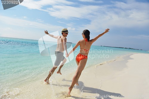 Image of happy young couple have fun on beach