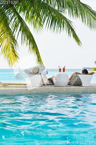 Image of happy young couple have fun on beach