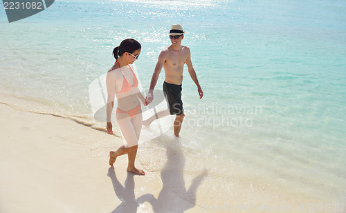 Image of happy young couple have fun on beach