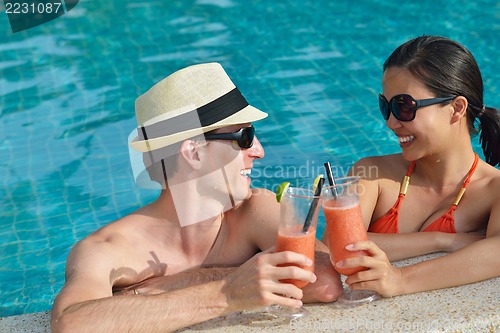Image of happy young couple have fun on beach