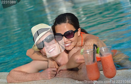Image of happy young couple have fun on beach