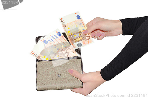 Image of Beautiful woman's hands holding purse with fan of money isolate