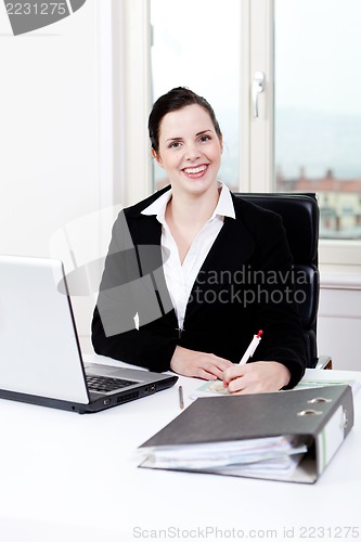 Image of young business woman in office