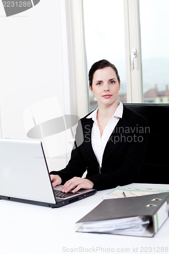 Image of young business woman in office