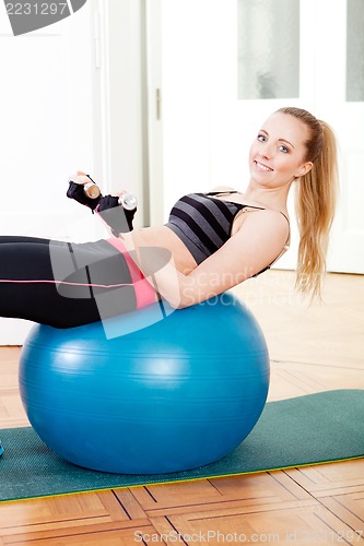 Image of attractive young woman doing fitness dumbbell