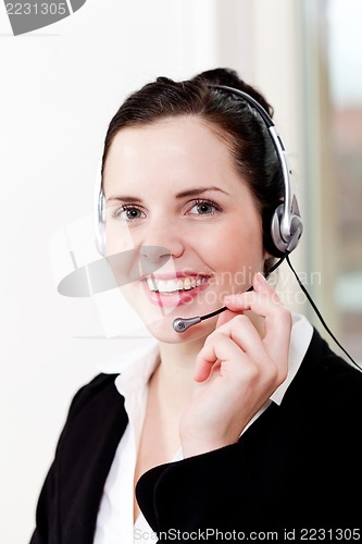 Image of smiling young female callcenter agent with headset