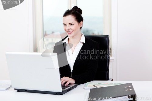 Image of young business woman in office