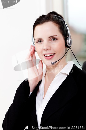 Image of smiling young female callcenter agent with headset