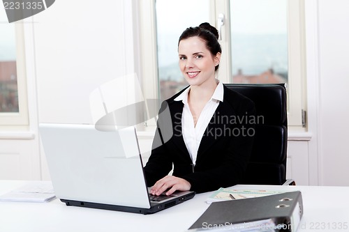 Image of young business woman in office