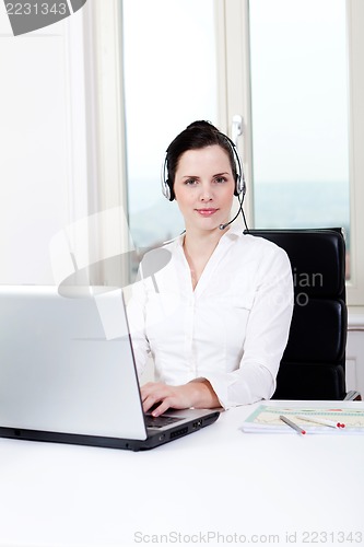 Image of smiling young female callcenter agent with headset