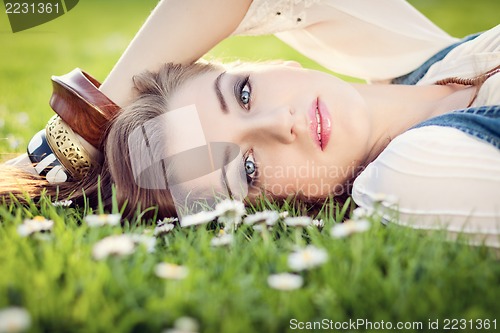 Image of beautiful woman lying in grass in summer 