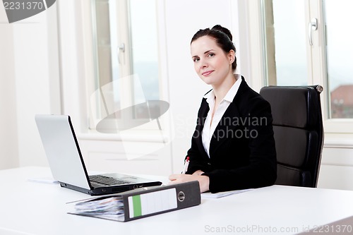 Image of young business woman in office