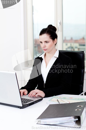 Image of young business woman in office