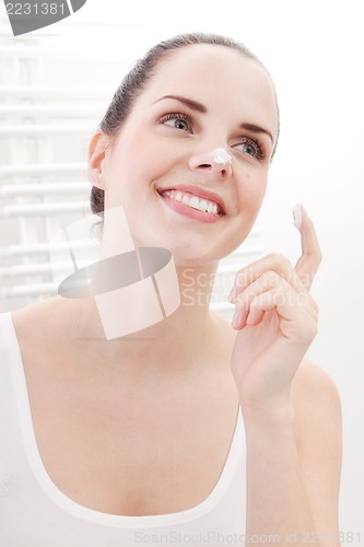 Image of apllying cream on face skincare