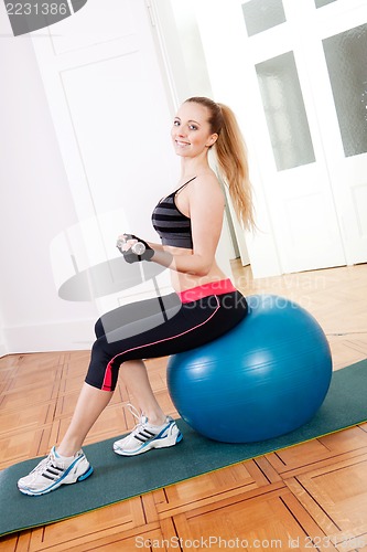 Image of attractive young woman doing fitness dumbbell