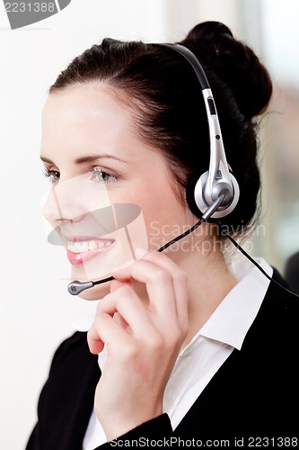 Image of smiling young female callcenter agent with headset