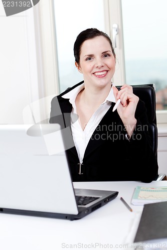 Image of young business woman in office