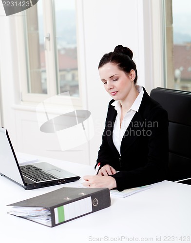 Image of young business woman in office
