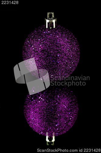 Image of christmas decoration in purple on black