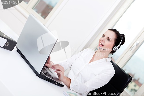 Image of smiling young female callcenter agent with headset