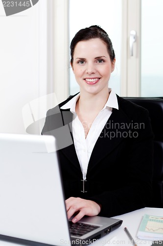 Image of young business woman in office