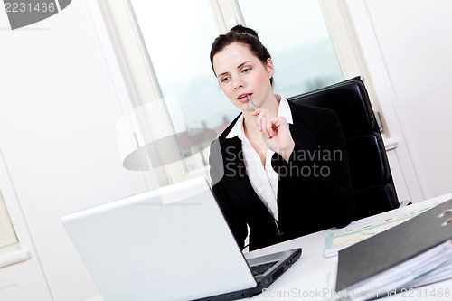 Image of young business woman in office