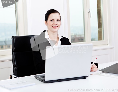 Image of young business woman in office