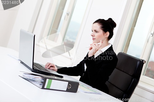 Image of young business woman in office