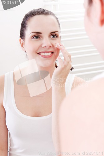 Image of apllying cream on face skincare