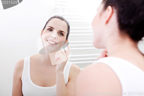 Image of apllying cream on face skincare