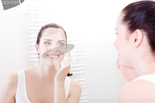 Image of apllying cream on face skincare
