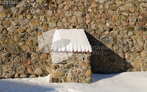 Image of vintage fort stone wall clay tile roof snow winter 