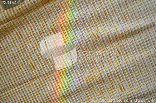 Image of artificial rainbow light yellow fabric background 