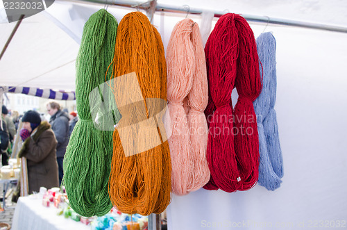 Image of woollen thread bunches sell outdoor market fair 