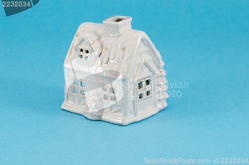 Image of white ceramic toy house decoration blue background 