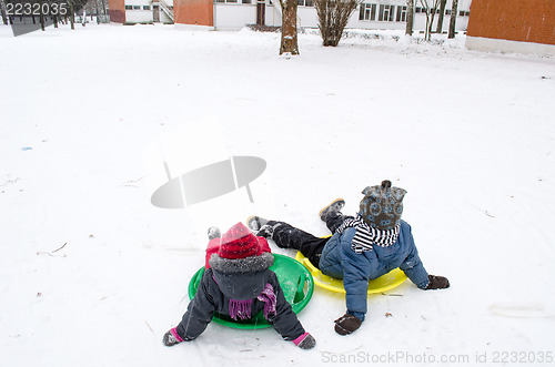 Image of children sitting on the slides weary after ride  