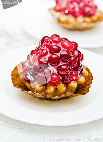 Image of Cake with a cranberry on a white plate