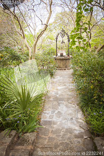 Image of Beautiful Lush Park Walkway and Antique Well