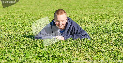 Image of Pretty boy lying on the fresh grass