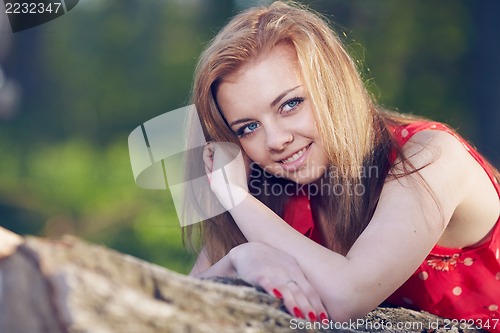 Image of Girl lying on a log