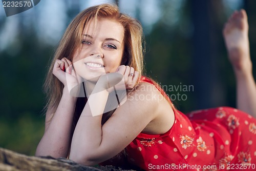 Image of Girl lying on a log