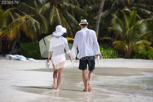 Image of happy young couple have fun on beach