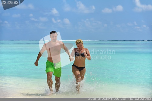 Image of happy young  couple at summer vacation have fun and relax at bea