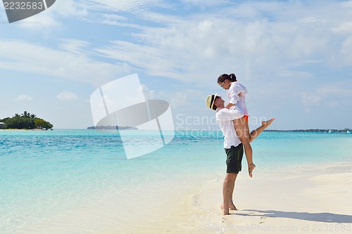 Image of happy young couple have fun on beach
