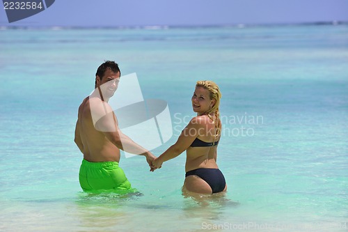 Image of happy young  couple at summer vacation have fun and relax at bea