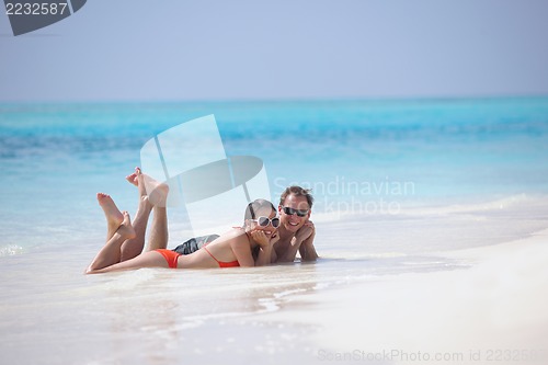 Image of happy young couple have fun on beach